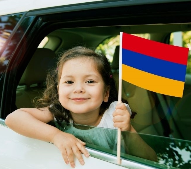 Armenian Girl holding up her flag