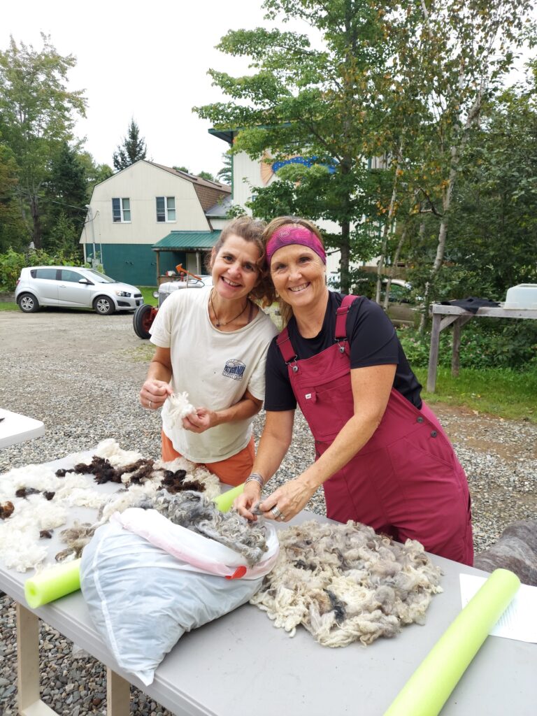 Two attendees organizing wool